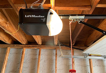 LiftMaster myQ Wi-Fi electric garage door opener mounted to ceiling in Leesburg, FL garage.