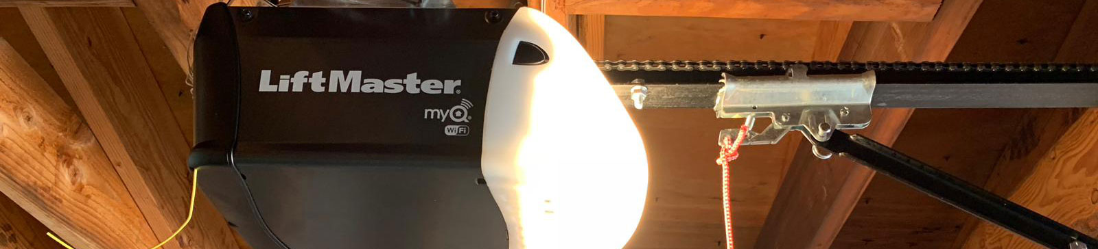 LiftMaster myQ Wi-Fi electric garage door opener mounted to ceiling in Leesburg, FL garage.